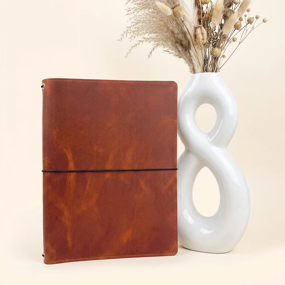 Handmade leather journal cover featuring three elastic bands and practical inner storage pockets.