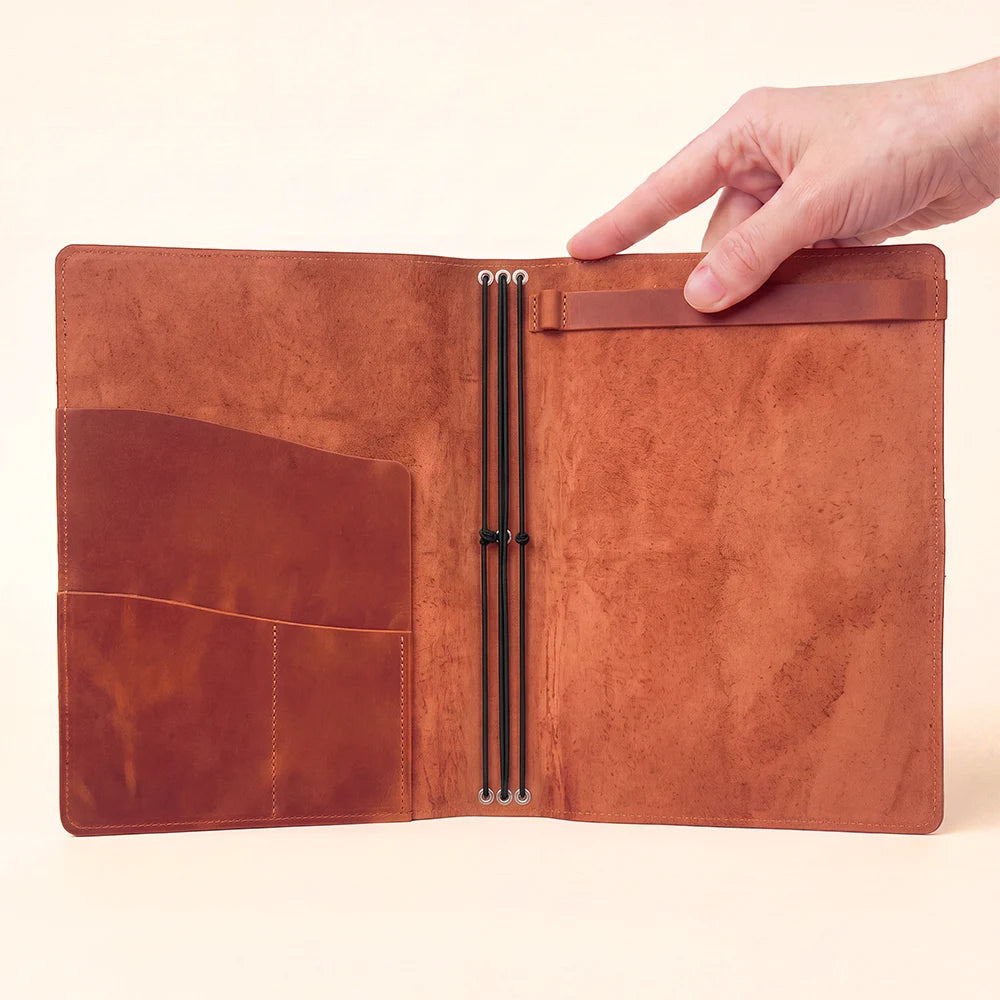 Refillable leather notebook cover with sketchbook attachment, pockets, and three elastic bands.