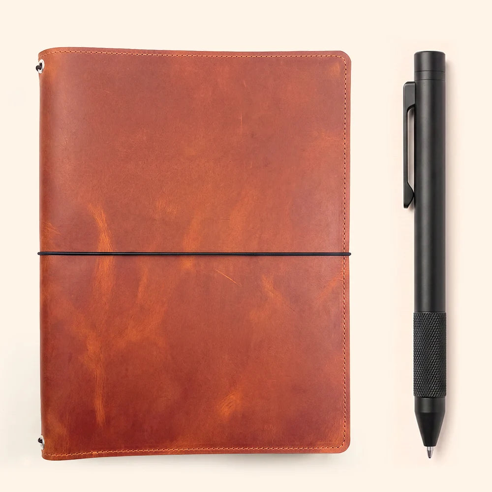 Natural leather journal cover with organized pockets and secure elastic notebook inserts.