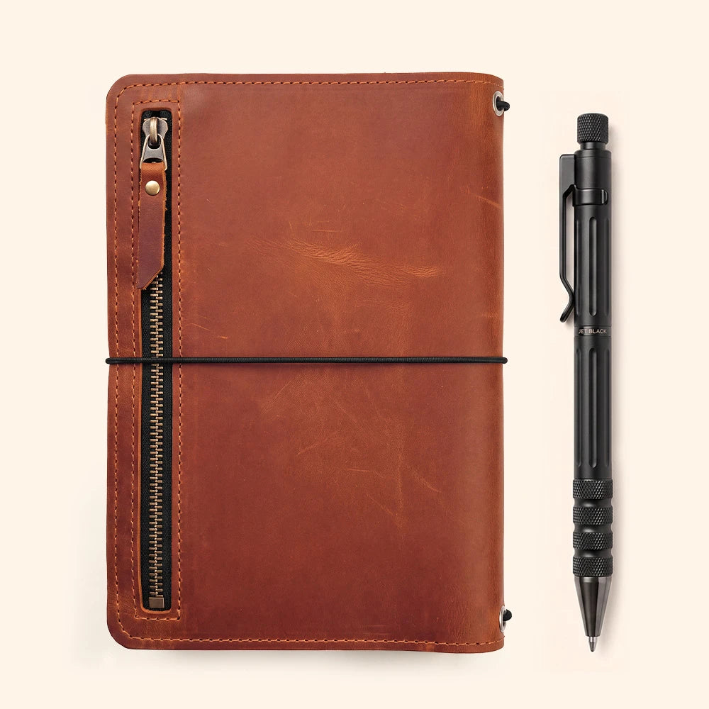 Genuine leather notebook wrap featuring organized interior layout and integrated pen carrier