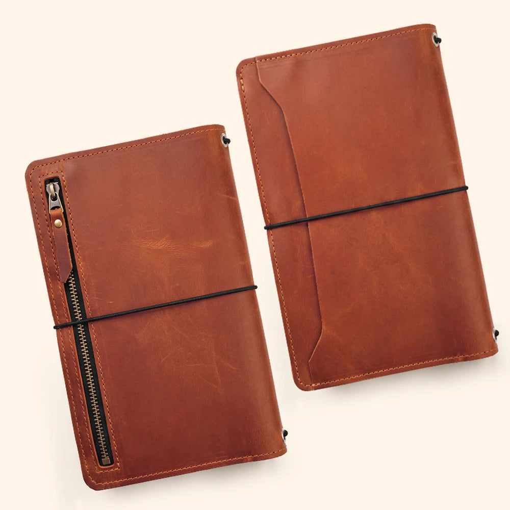 Handmade leather notebook carrier with document sleeves and convenient writing tool holder.