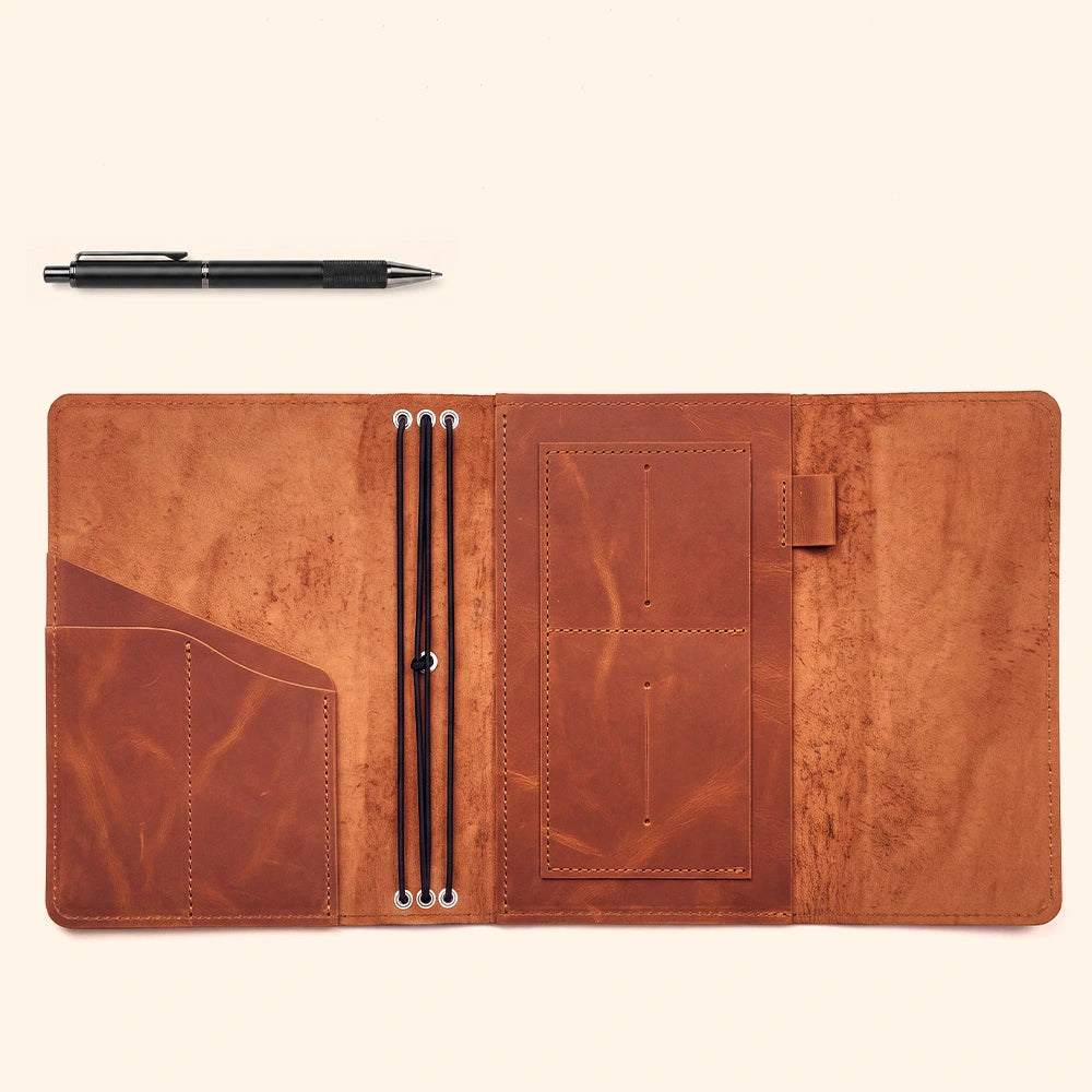 Genuine leather notebook wrap featuring dedicated compartments and secure leather pen loop design.