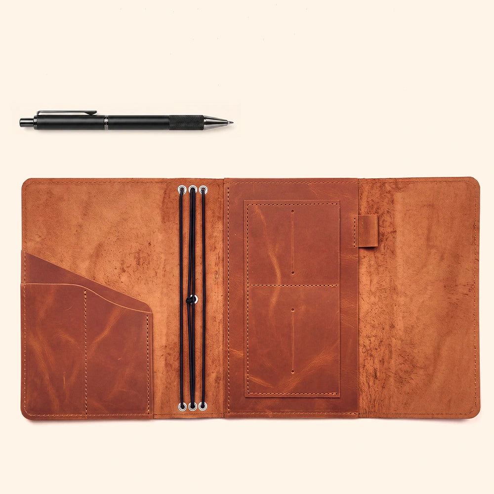 Handmade genuine leather notebook cover with organized compartments and secure leather pen sleeve.