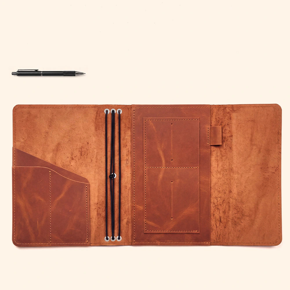 Premium handcrafted leather notebook holder featuring organized storage and dedicated pen loop.