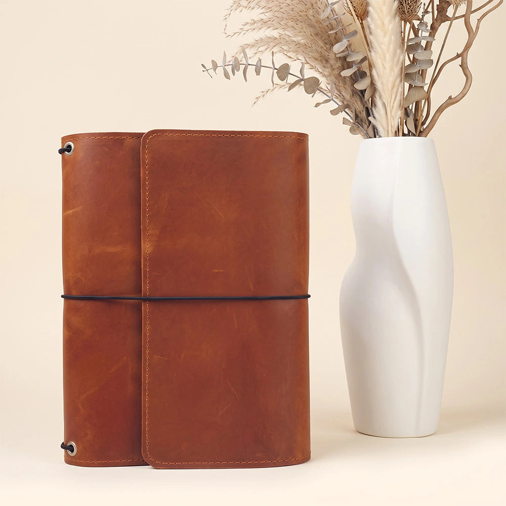 Genuine leather planner portfolio with practical interior organization and stitched leather pen sleeve.