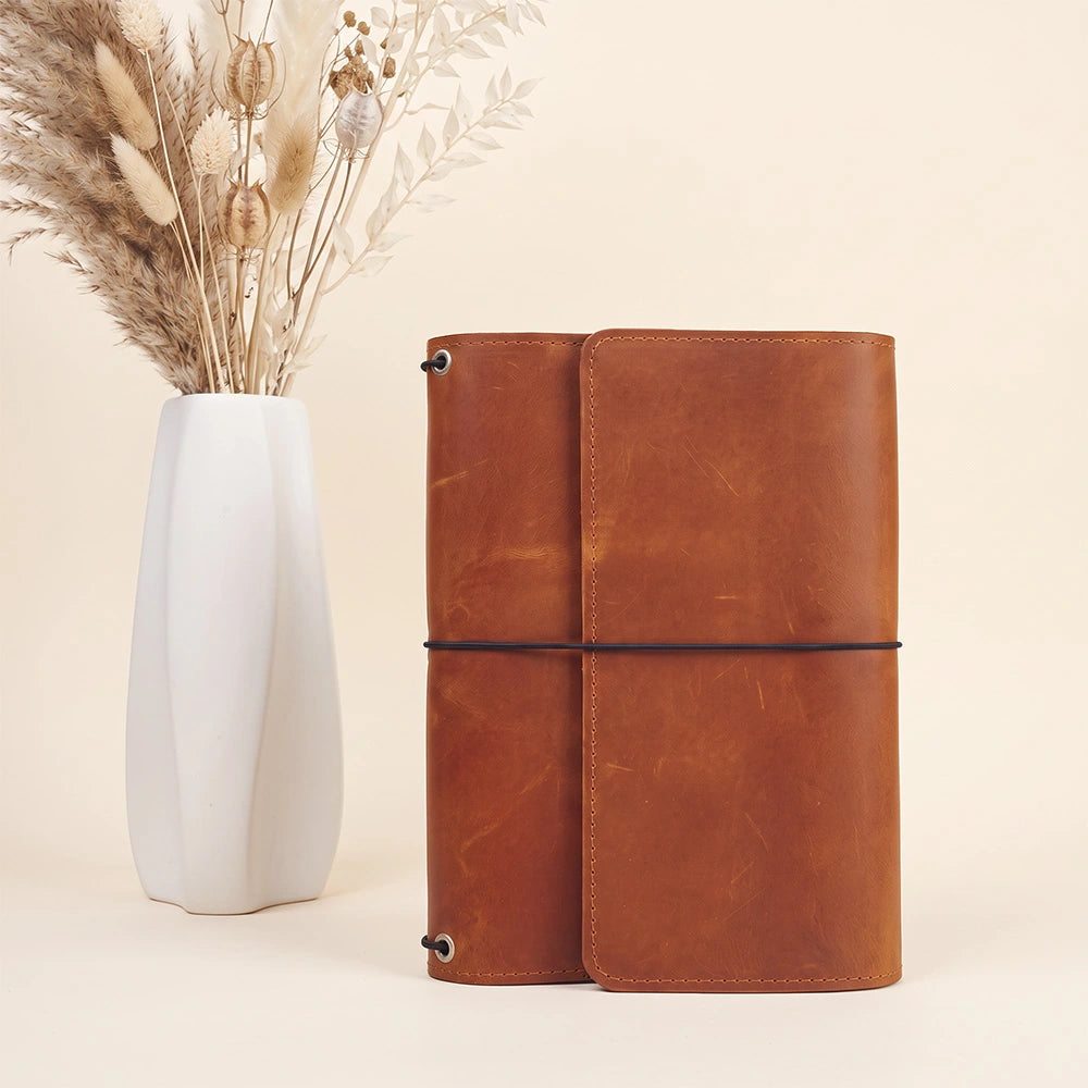 Leather notebook portfolio with interior organization and convenient leather writing instrument loop.