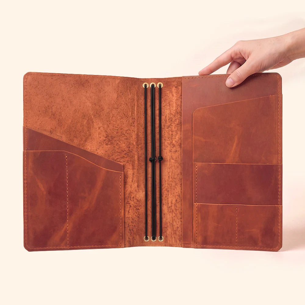 Reusable leather notebook holder allowing easy switching between three paper refills.