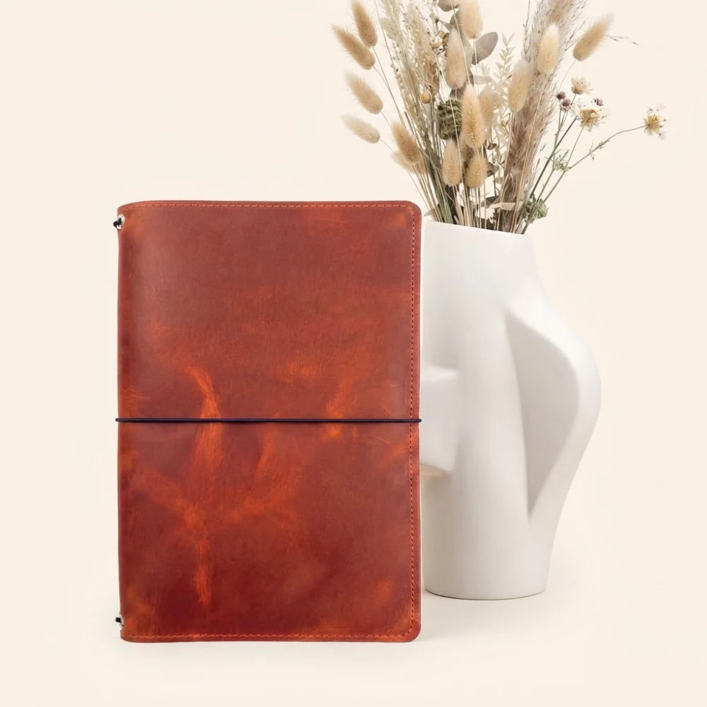 Premium handmade leather cover designed to hold three notebook inserts securely.