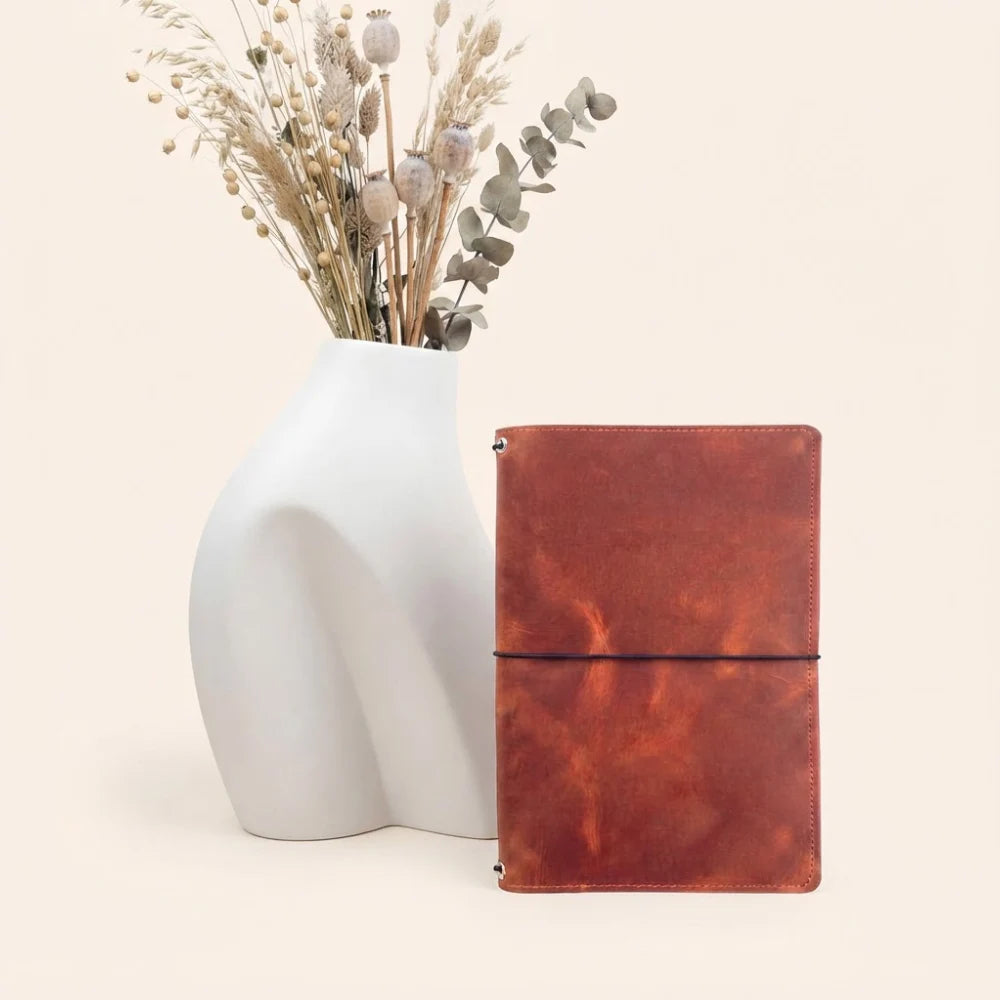 Handmade journal cover crafted from natural leather with three flexible elastic holders.