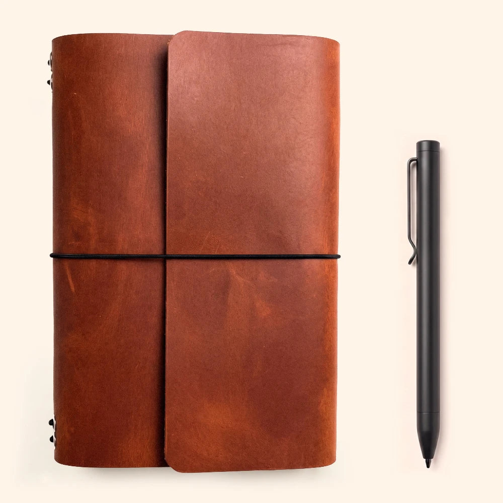 Refillable leather writing case with six elastic supports for interchangeable journal inserts.