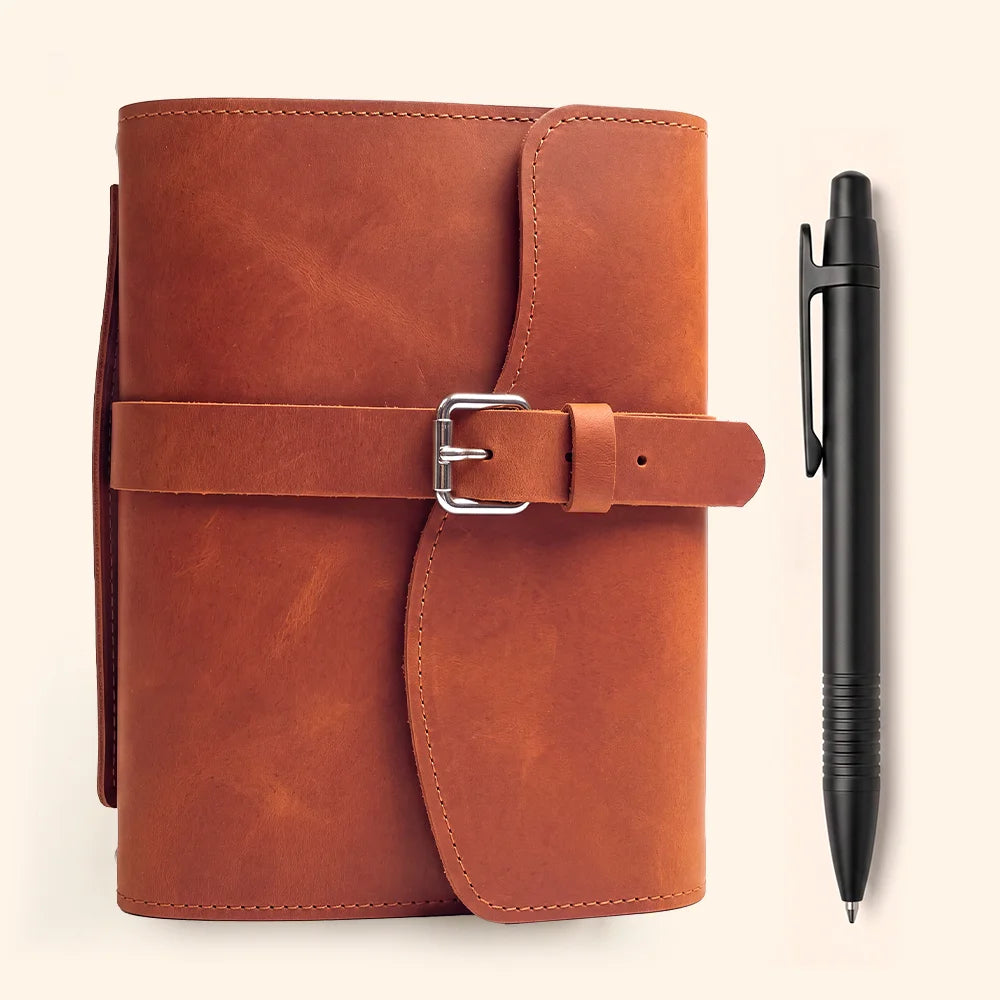 Handcrafted leather planner cover with inner storage slots, pen loop, fixed bookmark, and useful carry handle.