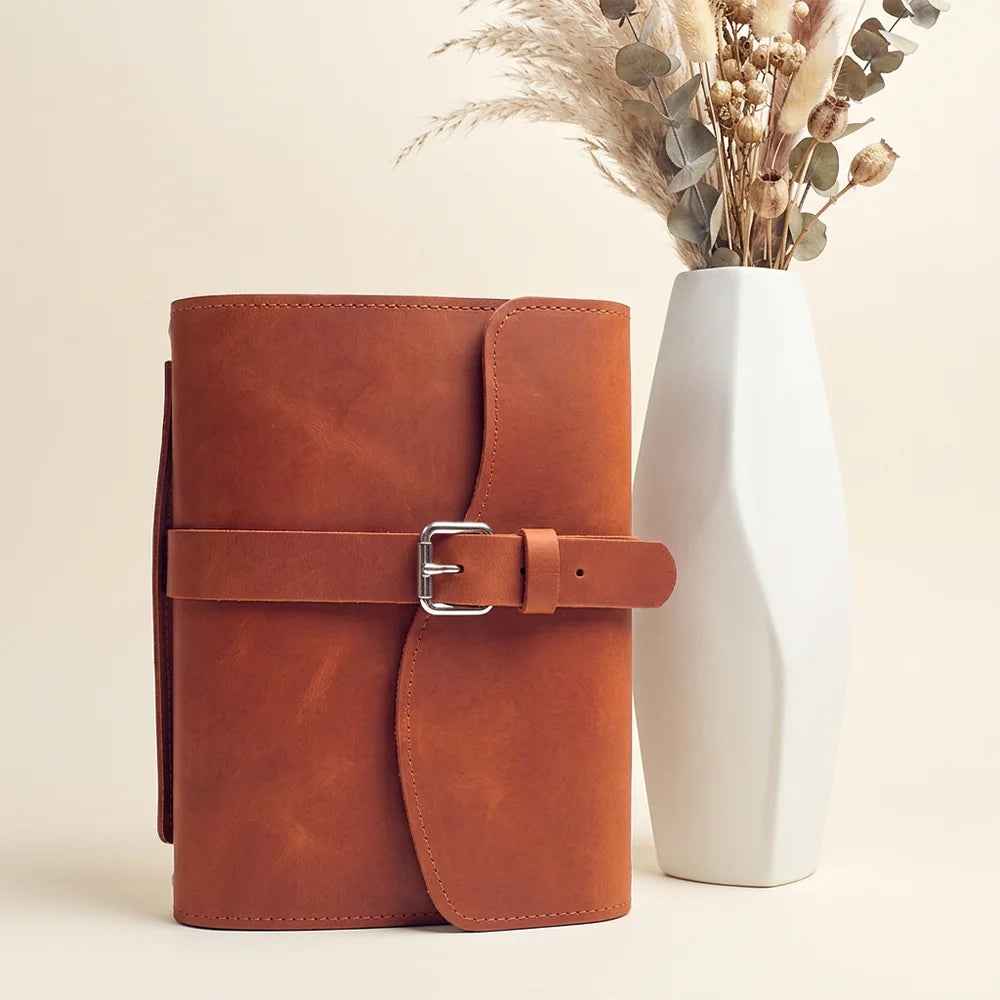 Premium leather journal organizer with storage sections, pen loop, integrated bookmark, and durable exterior grip.