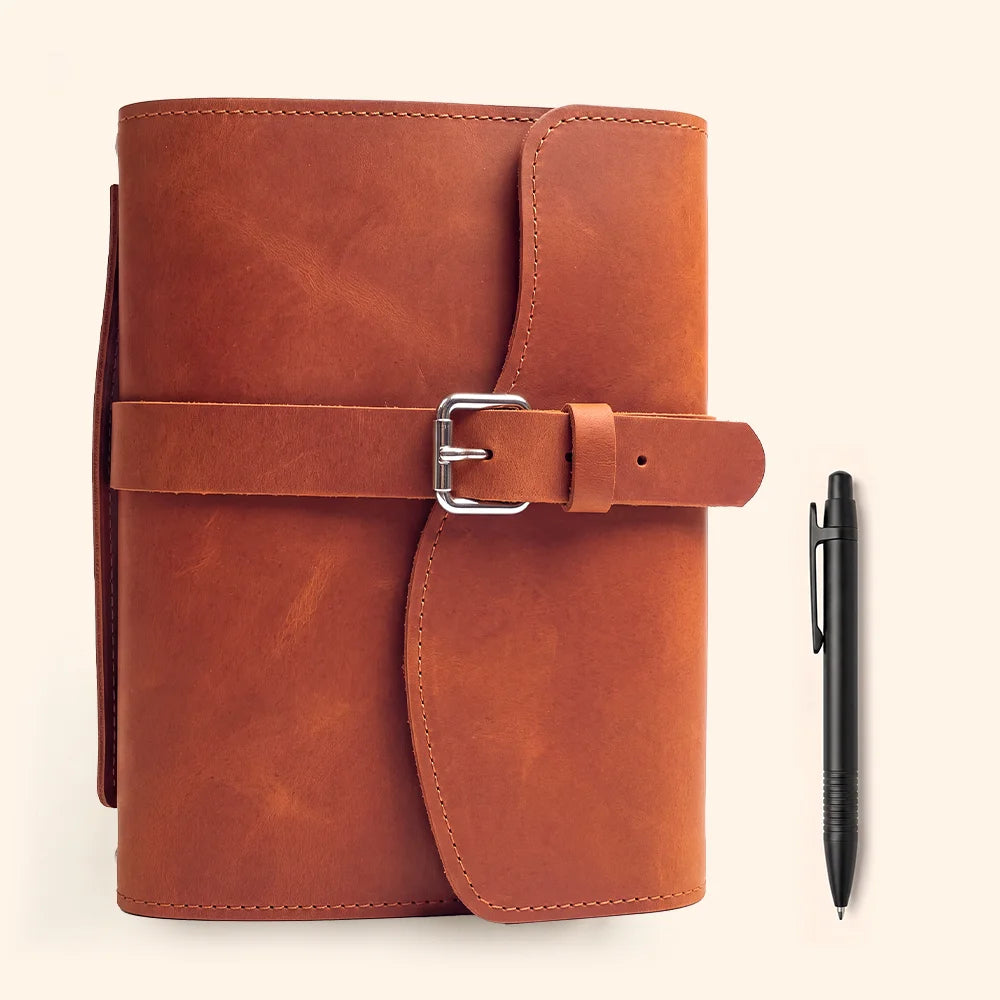 Genuine leather planner holder with useful compartments, pen loop, attached bookmark, and comfortable carrying grip.