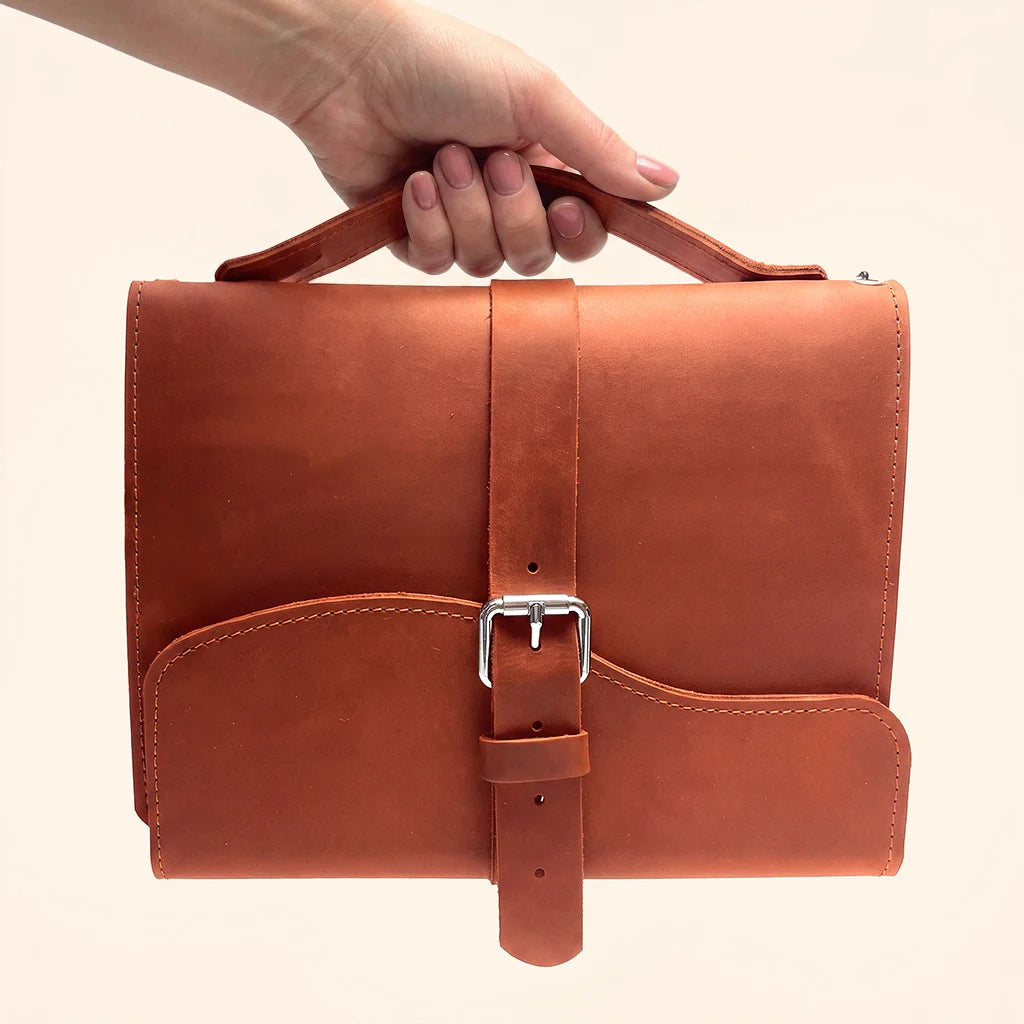Genuine leather cover for refillable notebooks with three elastic loops inside.