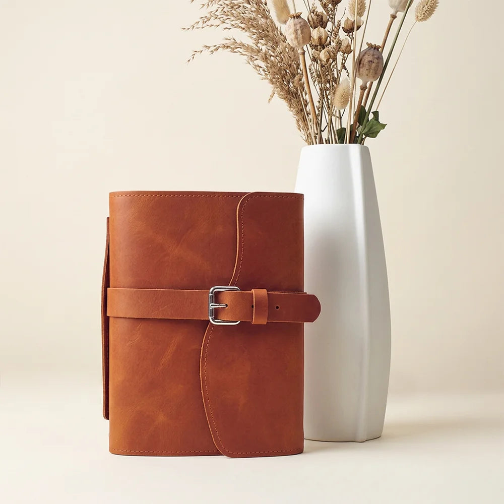 Natural leather journal cover featuring storage pockets, pen holder, built-in bookmark, and external handle.