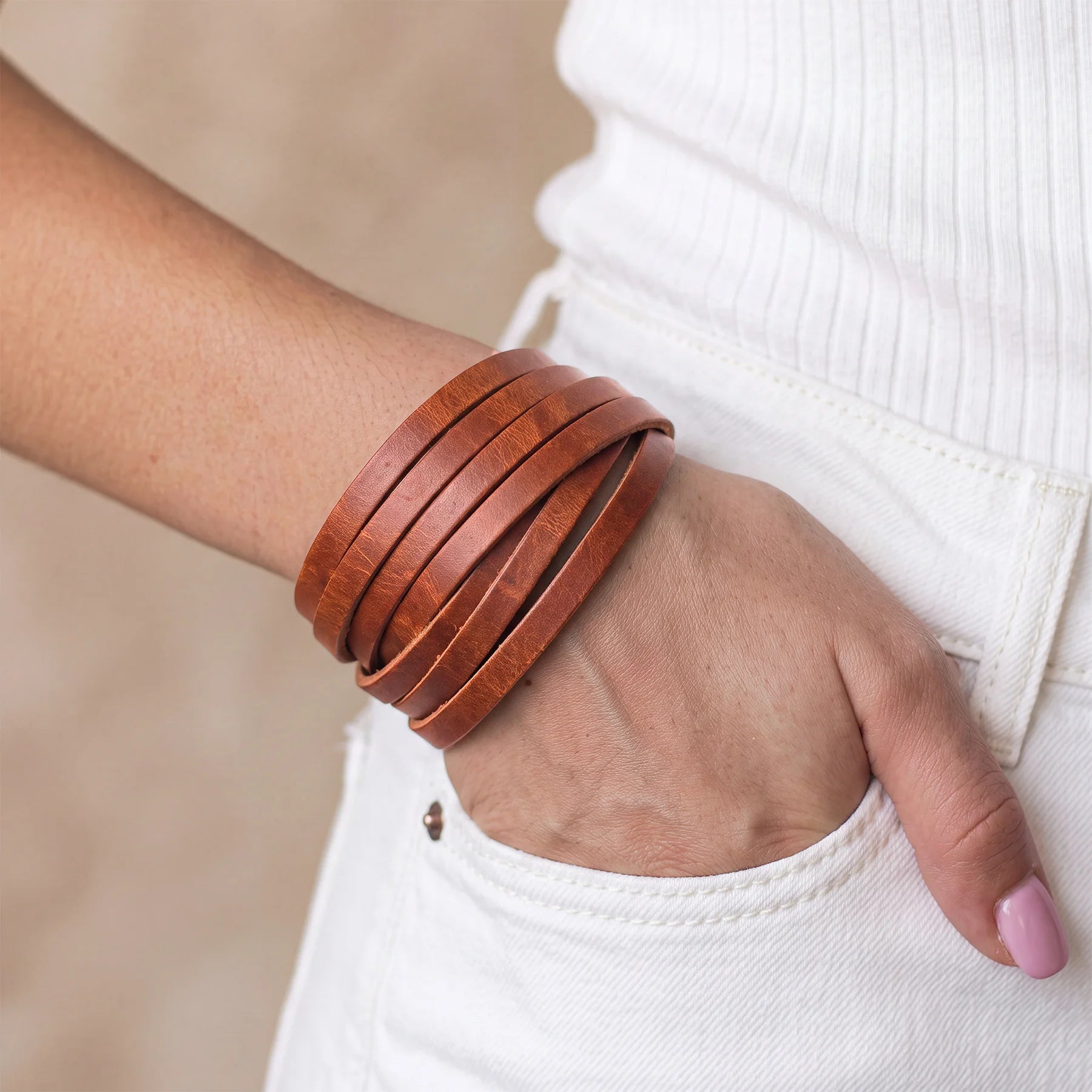 Minimalist leather bracelet crafted from genuine leather with reliable snap button closure.