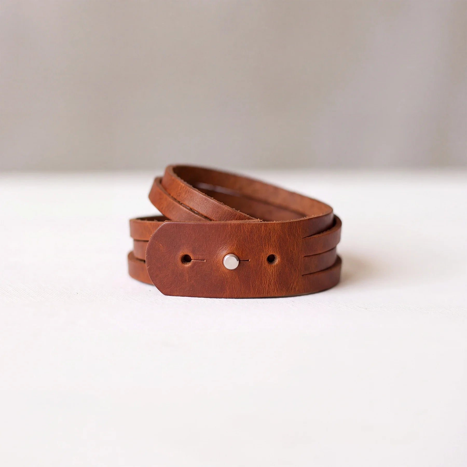 Handmade leather cuff bracelet with smooth natural leather and secure button fastening.