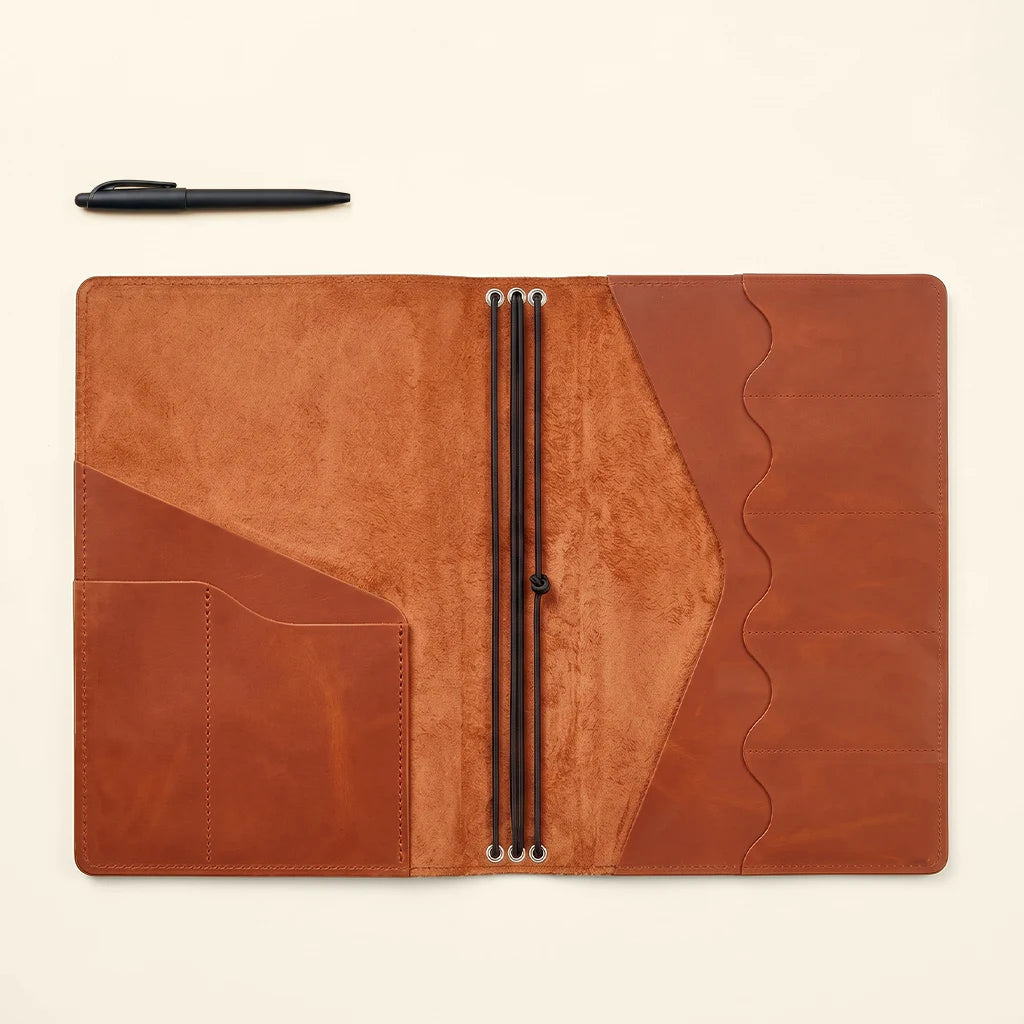 Refillable planner cover displaying handcrafted leather texture and fine stitching.