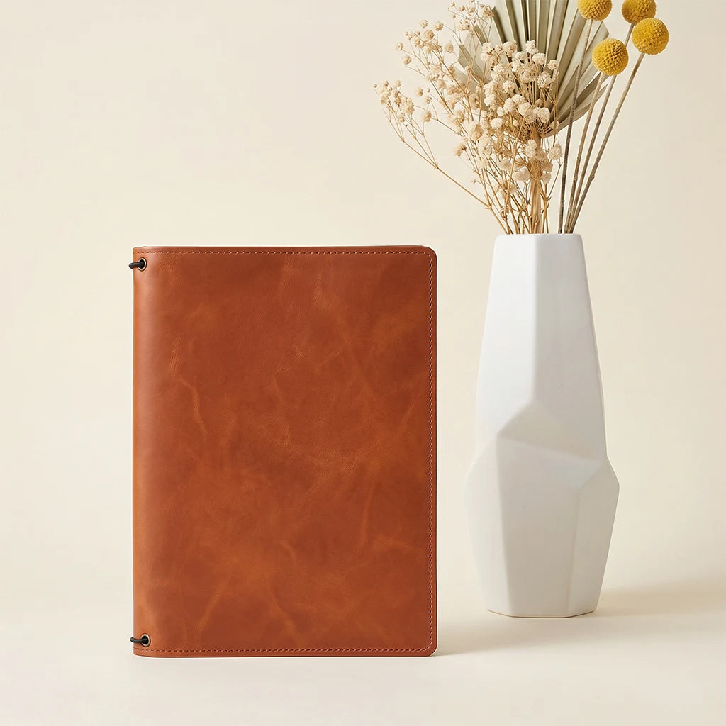 Refillable journal cover crafted from genuine leather with card pockets.