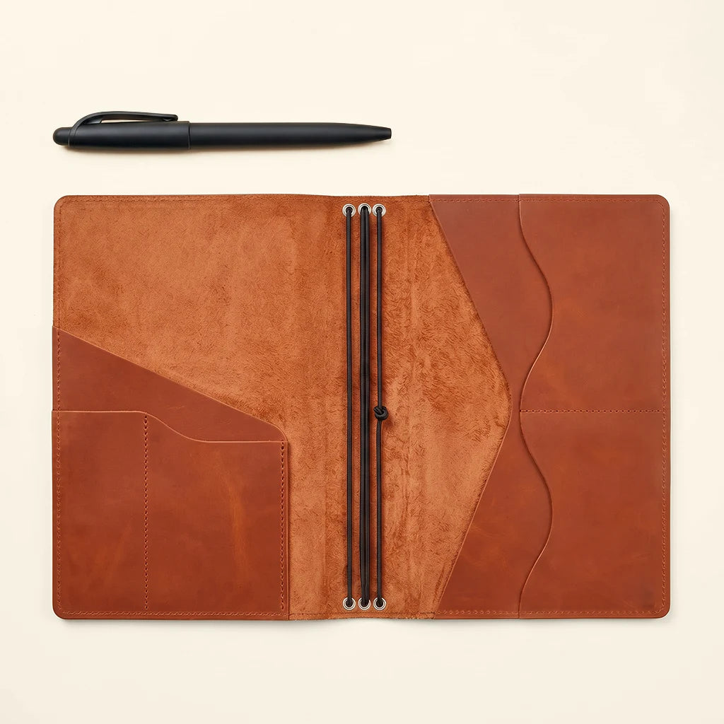 Handmade leather notebook cover with three elastics and practical inner pockets.