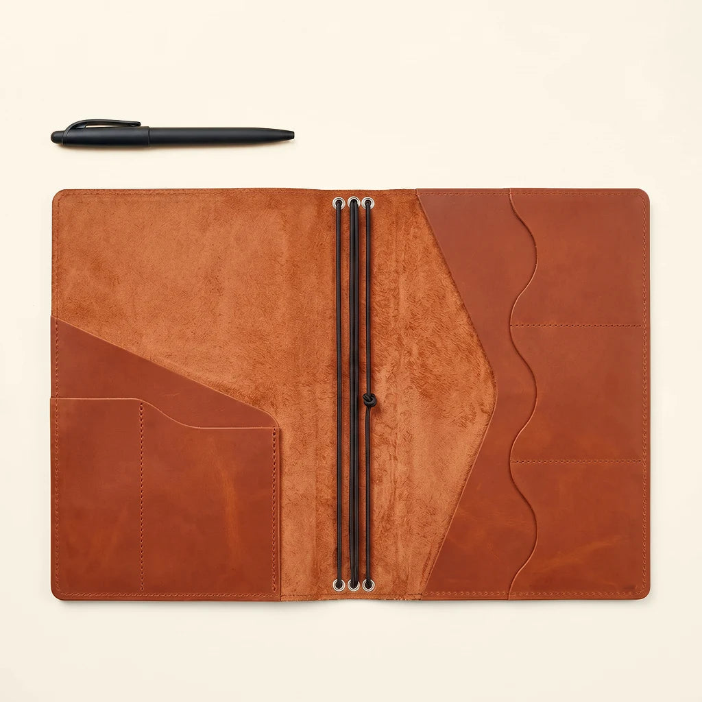 Refillable journal cover with handcrafted construction and versatile interior layout.