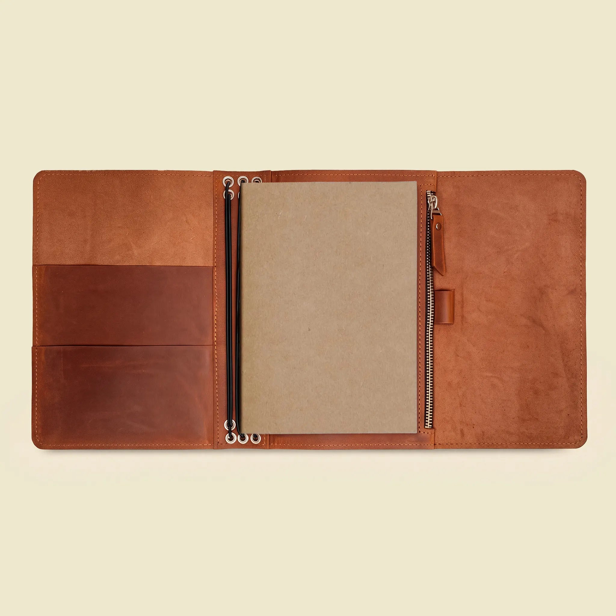 Leather notebook portfolio featuring three elastic supports and convenient interior pockets.