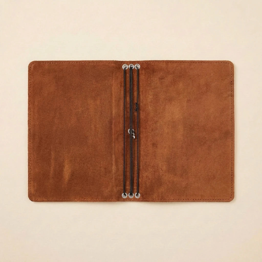 Brown leather case with metal clasps on a beige background