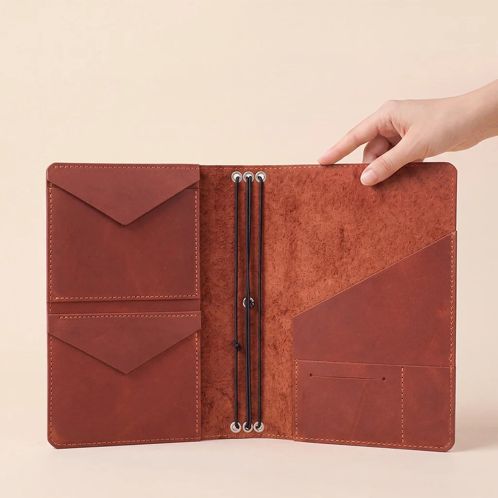 Leather journal cover with spacious organizer compartments and refillable elastic insert system.