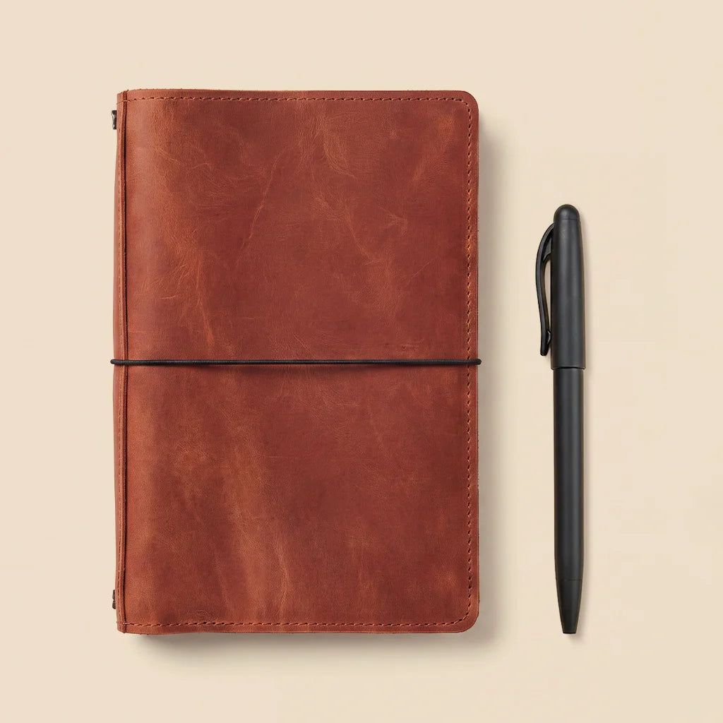 Genuine leather notebook cover built for refillable journals with organized interior storage.
