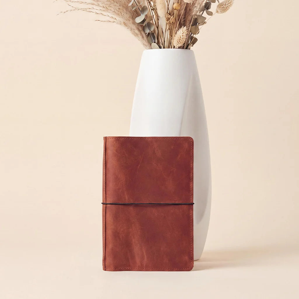 Leather journal organizer showcasing premium craftsmanship, elastic bands, and inside storage pockets.