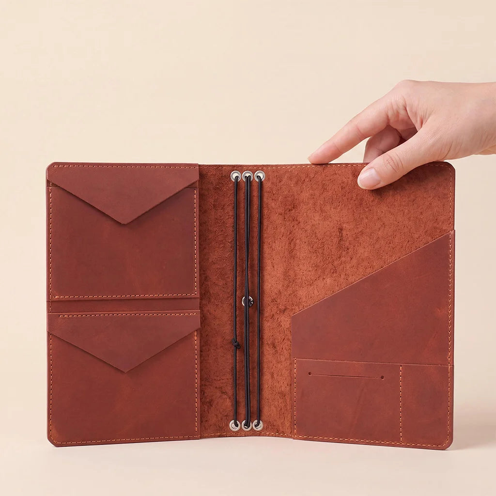 Refillable leather notebook organizer crafted from genuine leather with interior storage features.