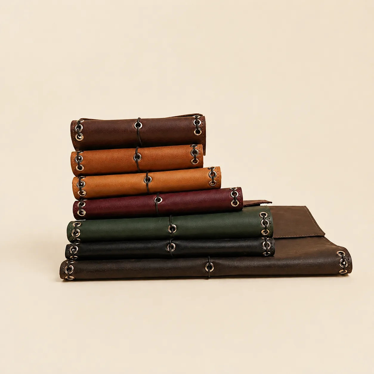 Rustic leather journal cover with three elastic cords and inner pockets.