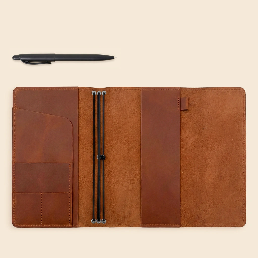 Handcrafted leather journal cover with organized pockets for everyday personal accessories.