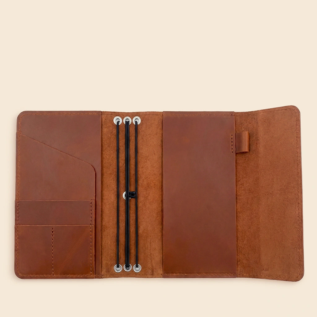 Genuine leather notebook cover with card pockets, elastic bands, and convenient pen holder.