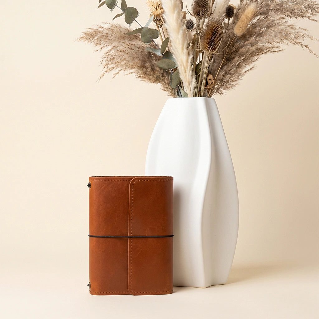 Genuine leather organizer cover featuring notebook elastics, pockets, and secure pen loop.