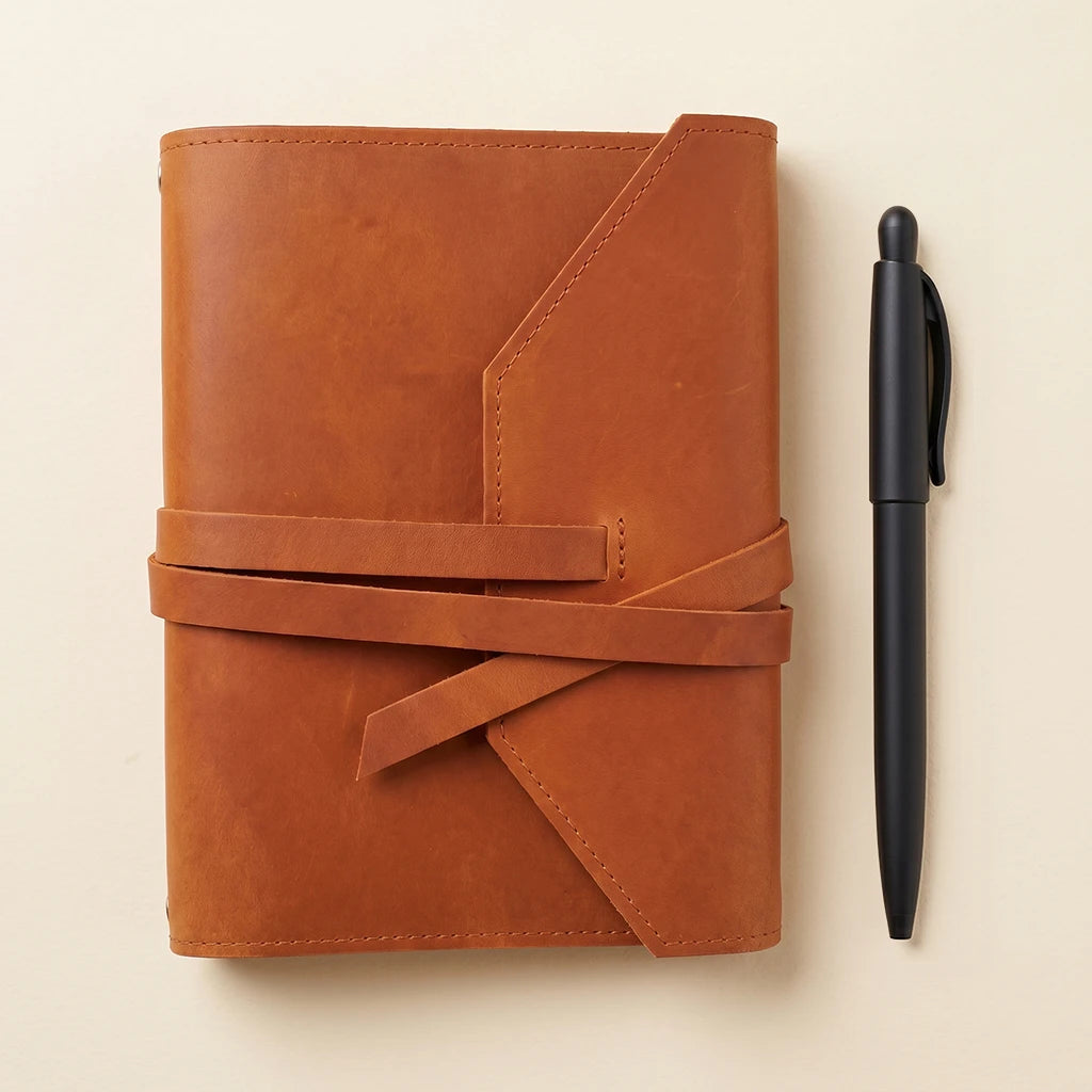 Customizable leather notebook cover with elastic bands and practical pen holder.