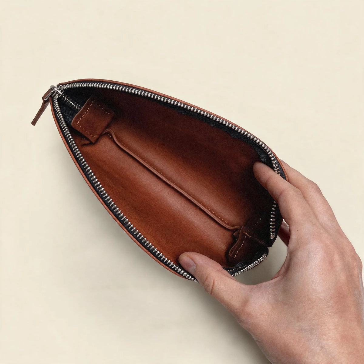 Handmade natural leather makeup pouch with zipper fastening and practical storage space