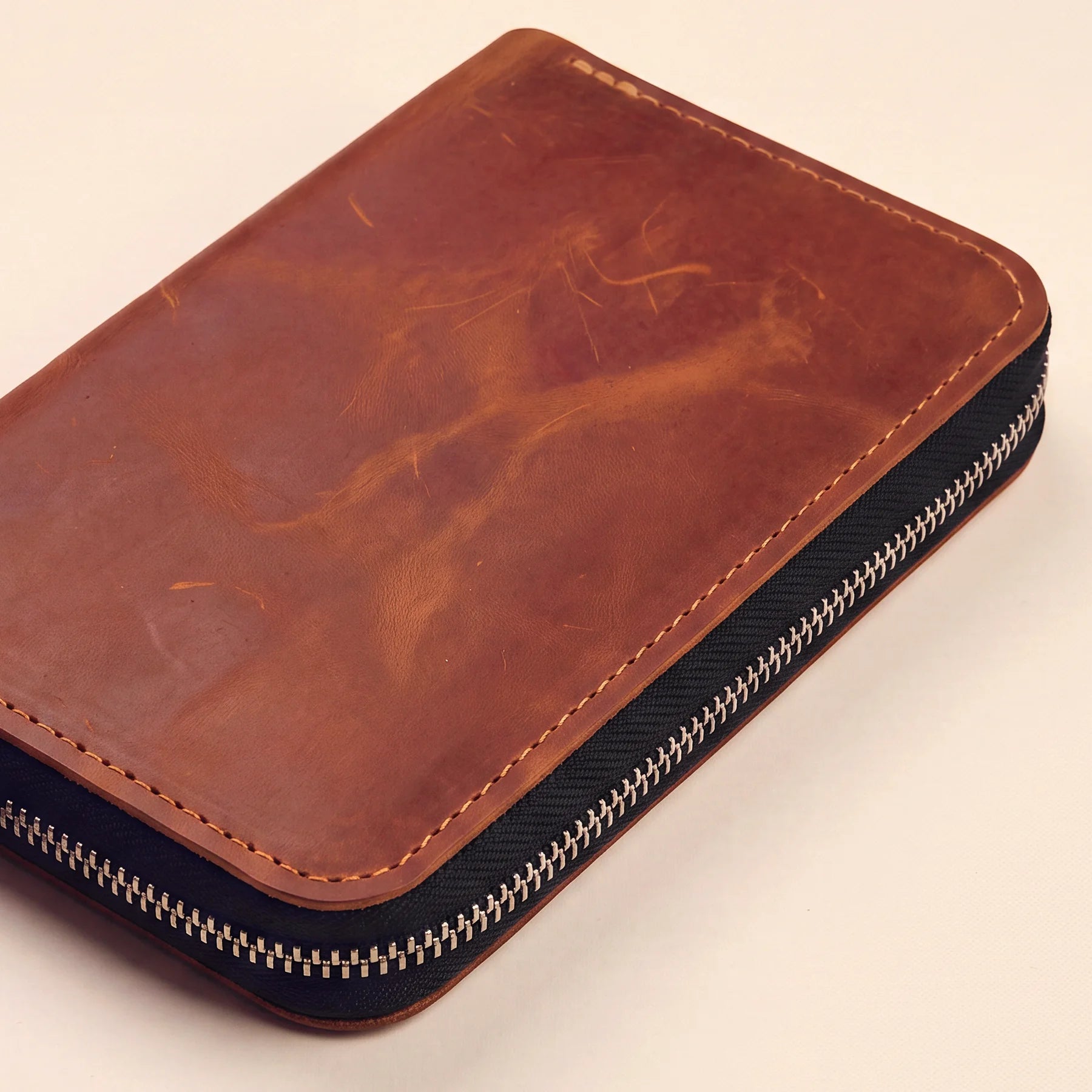 Handmade leather zipper pen pouch with durable construction and refined appearance.