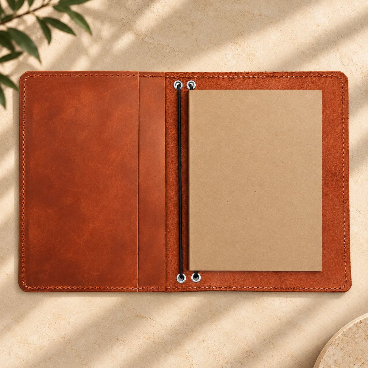 Natural leather journal holder featuring two elastic bands and neatly arranged inner pockets.