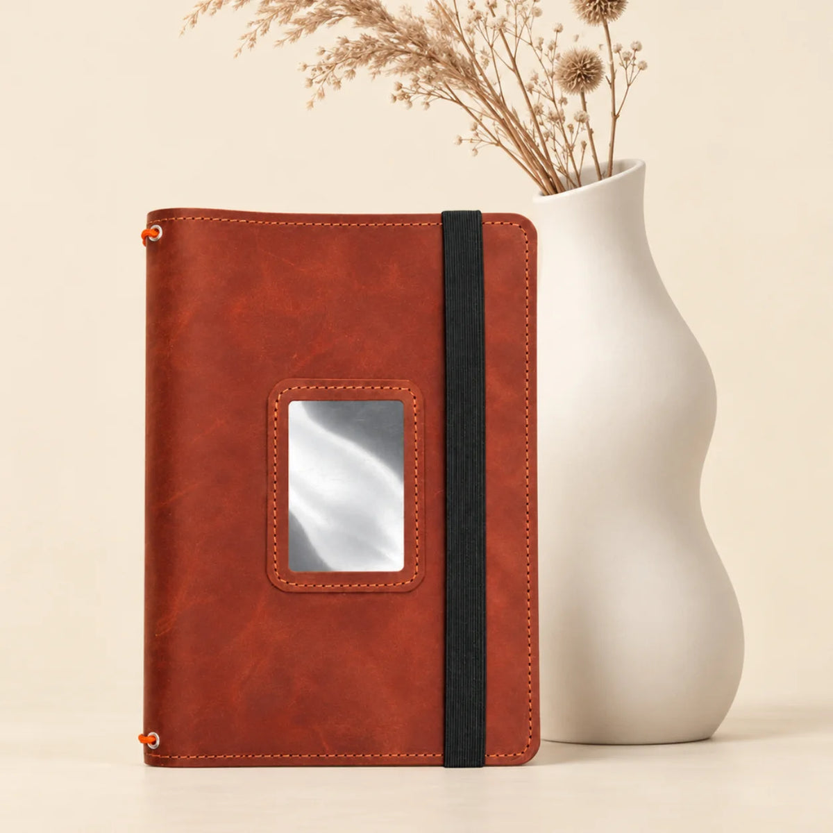 Genuine leather journal organizer displaying three elastic bands and several functional inner compartments.