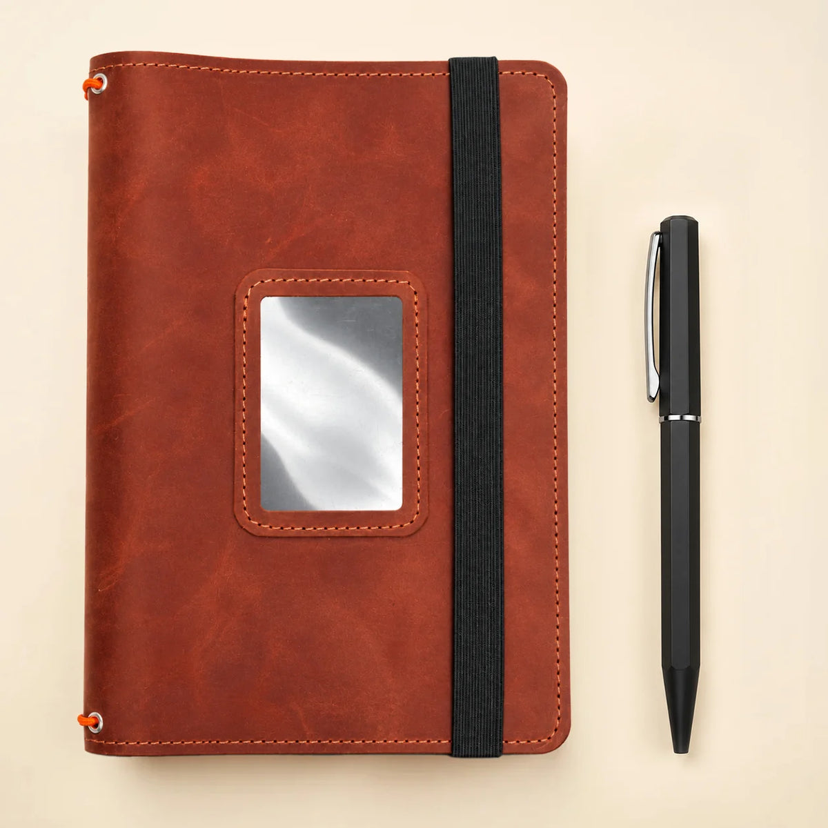 Natural leather notebook cover with three elastic holders and carefully positioned pockets inside.