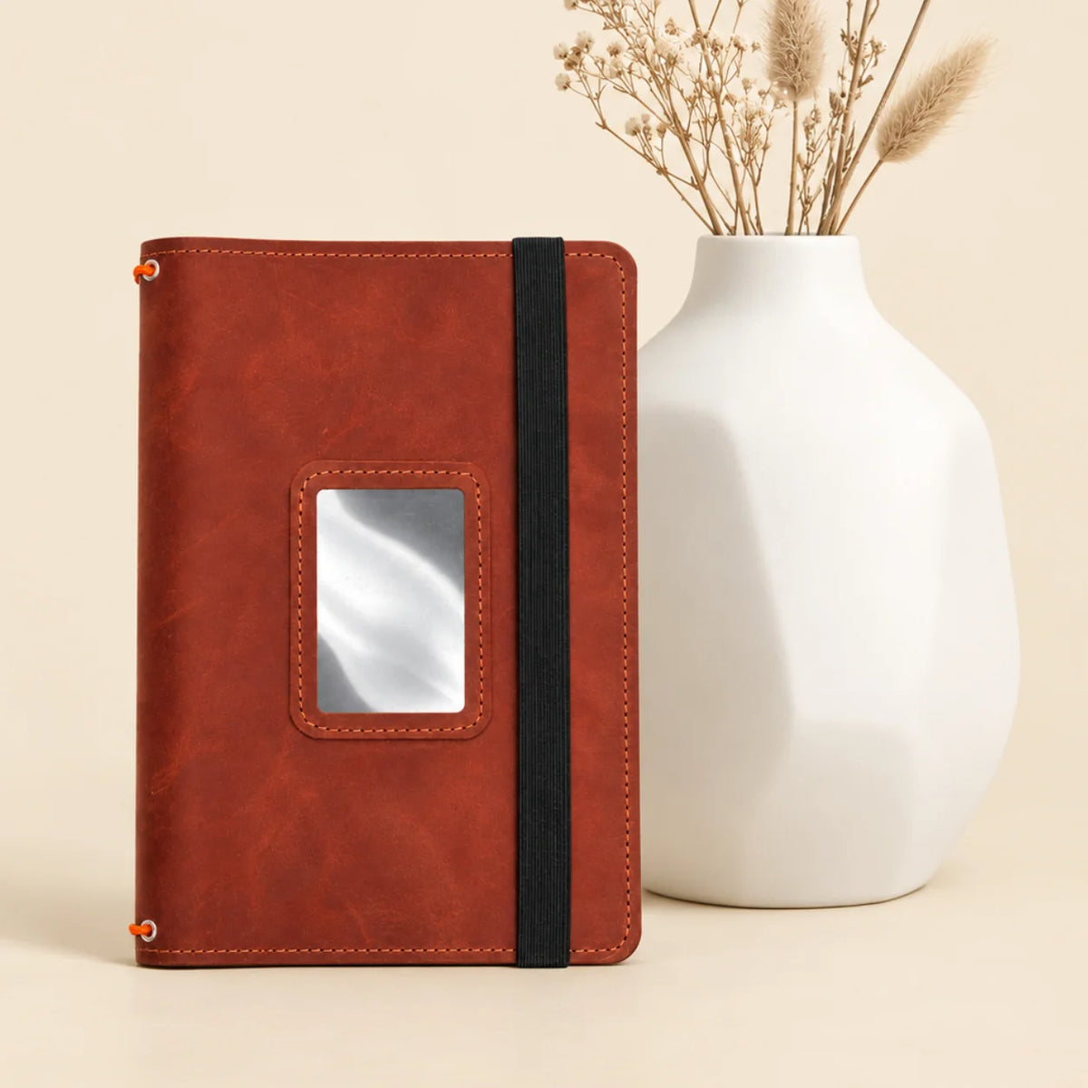 Genuine leather journal holder with three elastic bands and several convenient inner compartments.