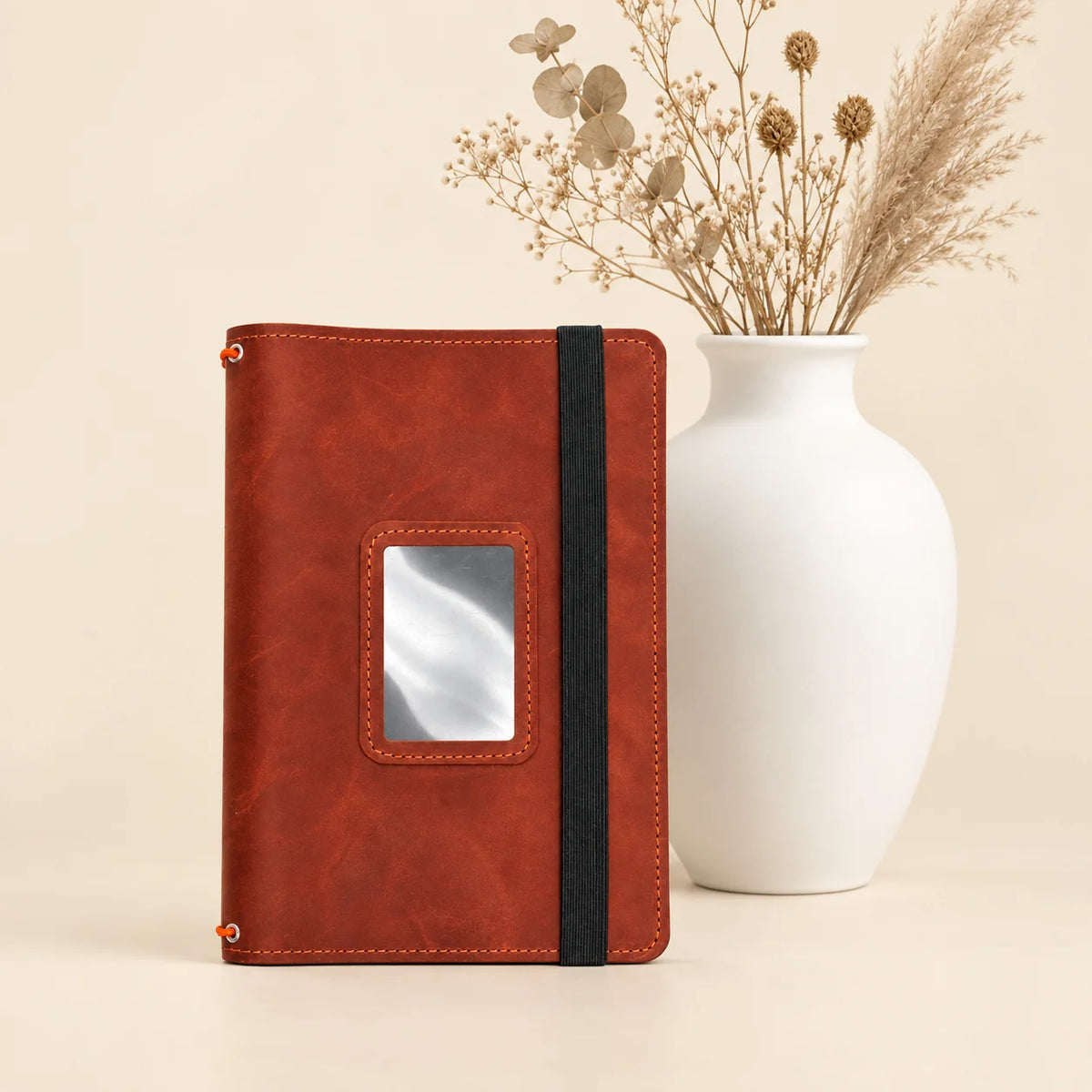 Leather journal cover featuring practical interior pockets and three elastic bands for notebooks.