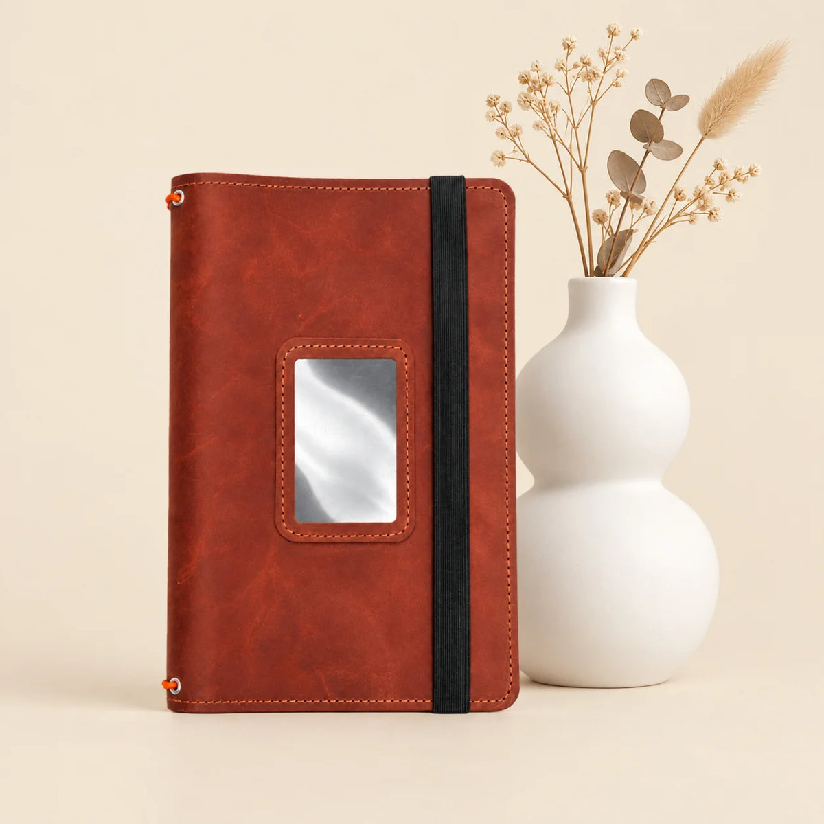 Genuine leather journal organizer with three elastic straps and spacious pockets beneath the cover.