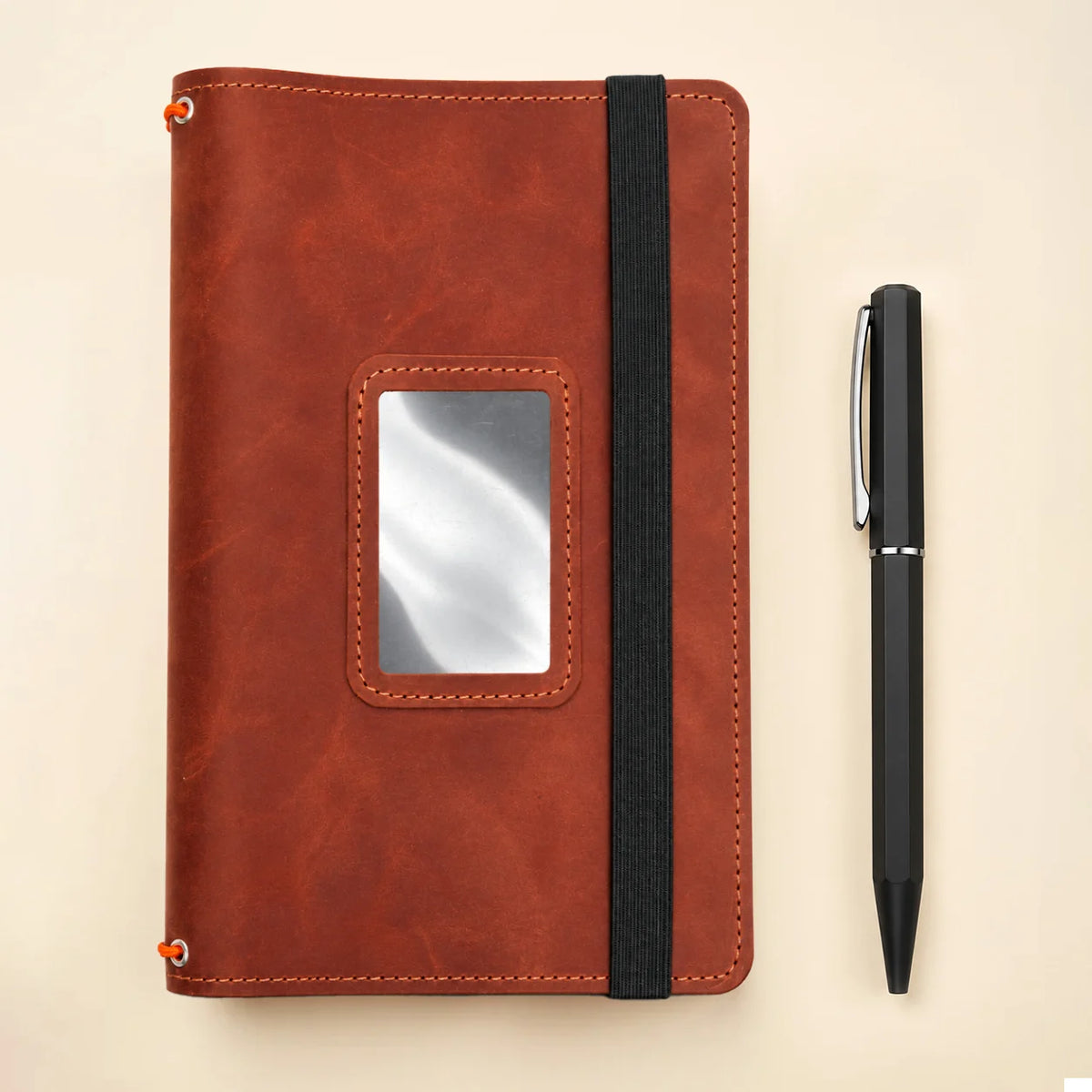 Natural leather notebook holder featuring three bands and multiple compartments for personal items.
