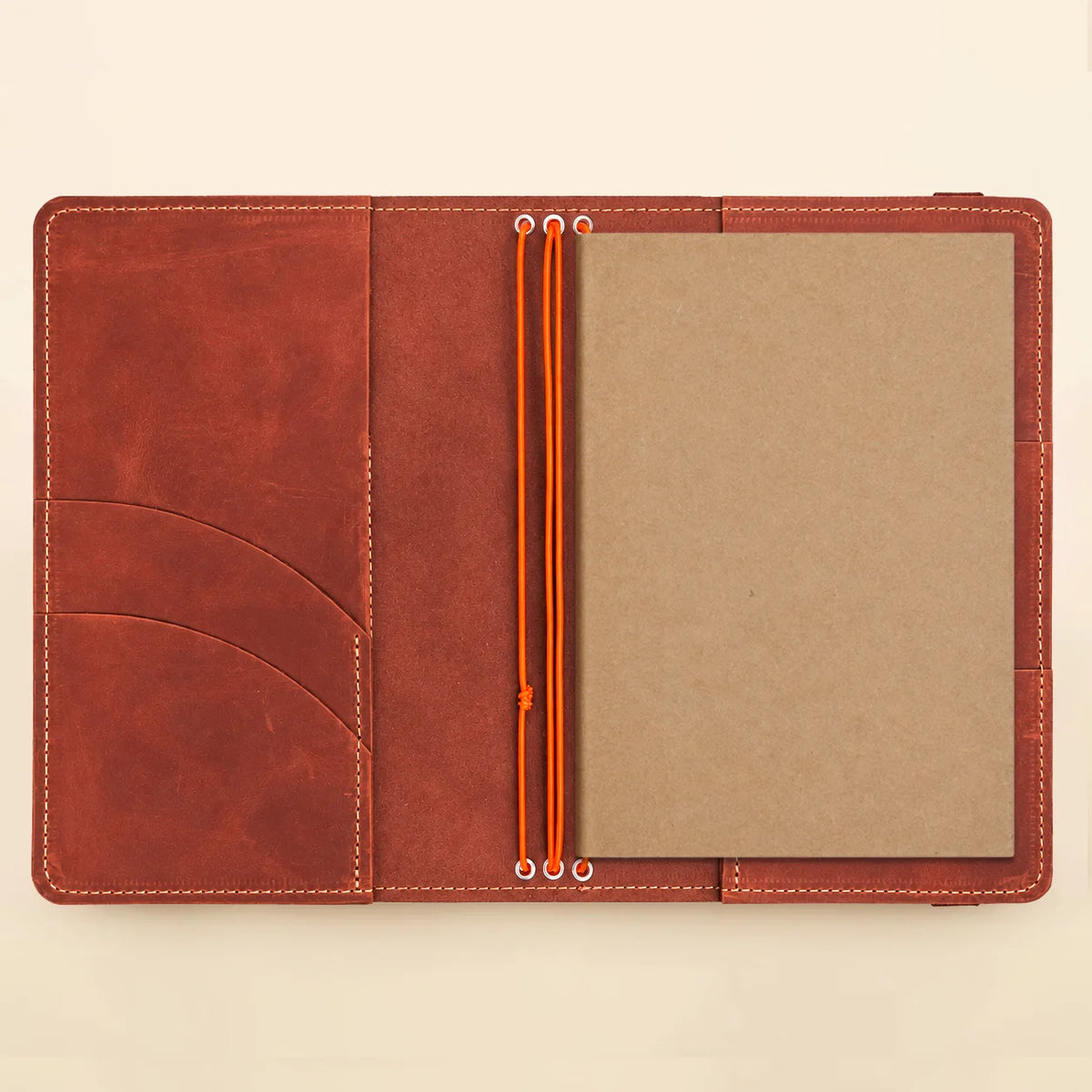 Handmade leather cover with three elastic notebook straps and discreet interior storage pockets.