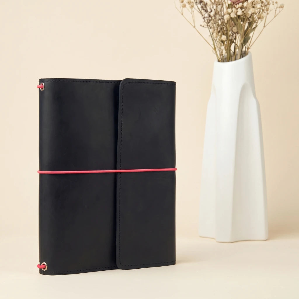 Handmade leather planner cover with elastic straps, card pockets, and pen holder