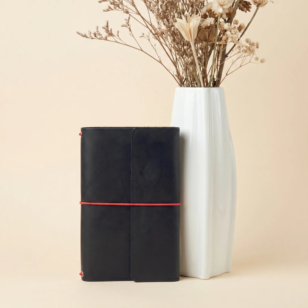 Leather journal organizer with elastic bands, pocket storage, and dedicated pen holder