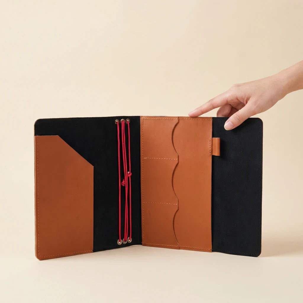 Genuine leather notebook case with elastic straps, inner sleeves, and pen loop detail