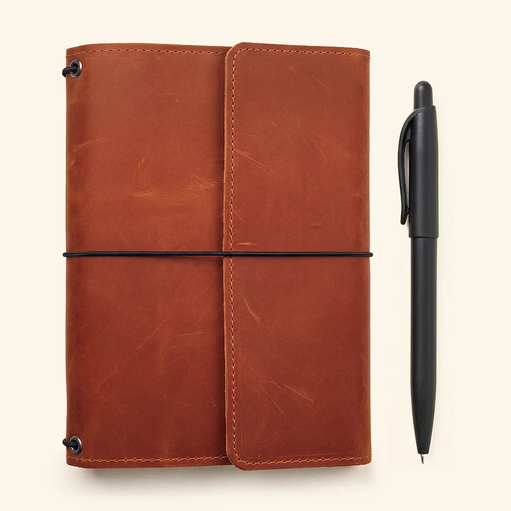 Premium handcrafted leather planner cover with refillable notebook system and interior organization.